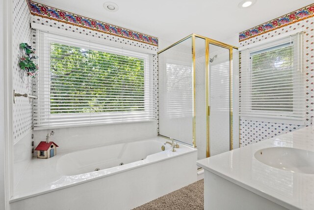 219 Ray Rd, Pottsboro, TX 75076 - full bathroom with plenty of natural light, a stall shower, a jetted tub, double vanity, and recessed lighting