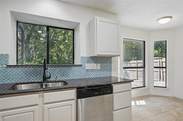 521 Bent Creek Dr, Garland, TX 75040 - kitchen with dishwasher, a sink, tasteful backsplash, dark stone countertops, and white cabinets