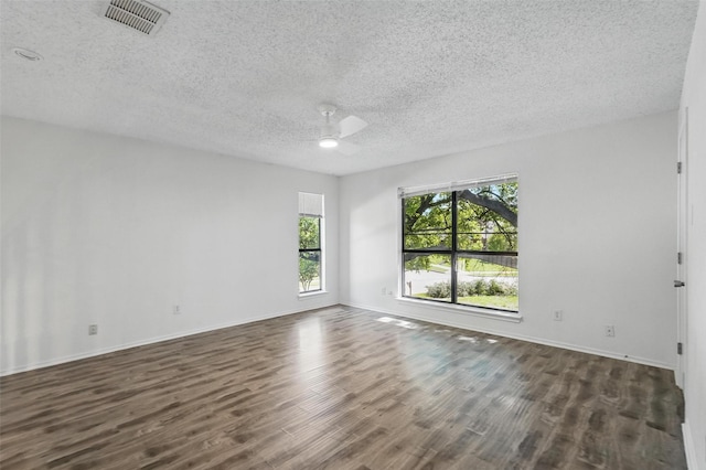 521 Bent Creek Dr, Garland, TX 75040 - unfurnished room featuring a ceiling fan, dark wood-style floors, a textured ceiling, and baseboards
