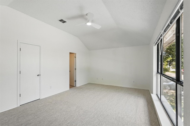 521 Bent Creek Dr, Garland, TX 75040 - unfurnished bedroom featuring vaulted ceiling, carpet floors, ceiling fan, and a textured ceiling