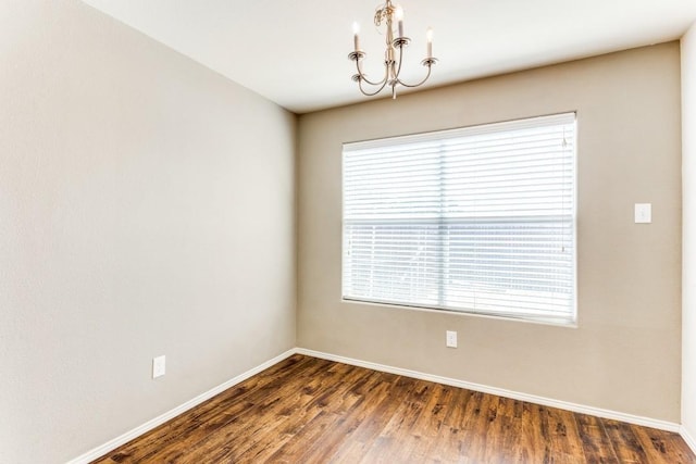 7500 Lazy Spur Blvd, Fort Worth, TX 76131 - empty room with a chandelier, dark wood-style flooring, baseboards, and plenty of natural light