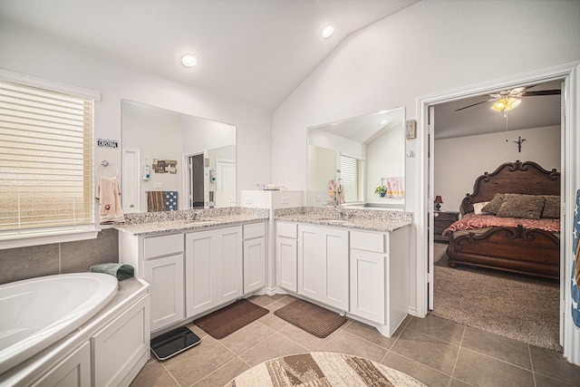 6505 Boot Jack Dr, Burleson, TX 76058 - bathroom with lofted ceiling, ensuite bath, tile patterned floors, two vanities, and a garden tub
