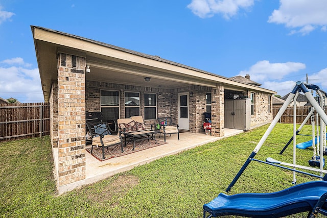 6505 Boot Jack Dr, Burleson, TX 76058 - rear view of house featuring a playground, brick siding, and a patio