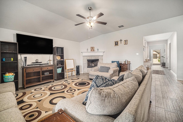 6505 Boot Jack Dr, Burleson, TX 76058 - living room with a ceiling fan, wood finished floors, vaulted ceiling, a tiled fireplace, and baseboards