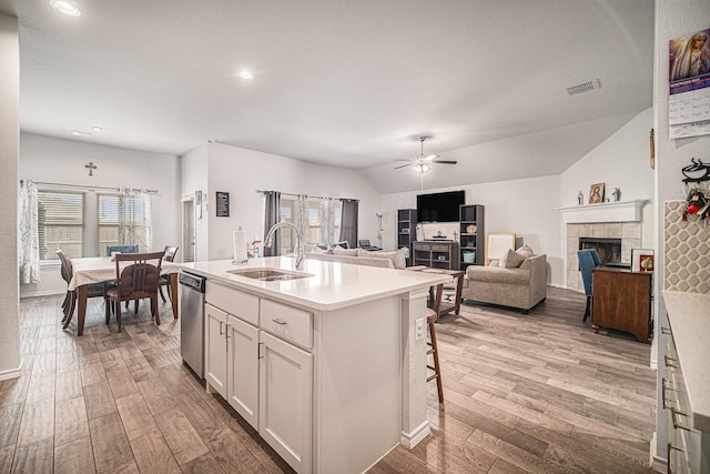 6505 Boot Jack Dr, Burleson, TX 76058 - kitchen with a sink, wood finished floors, vaulted ceiling, a ceiling fan, and light countertops