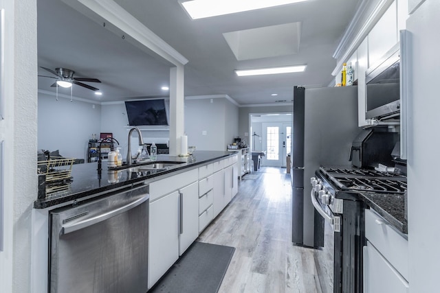 2801 Peachtree Ln, Pantego, TX 76013 - kitchen featuring stainless steel appliances, a sink, ornamental molding, white cabinetry, and dark stone countertops