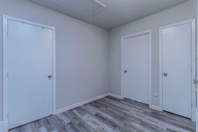 2801 Peachtree Ln, Pantego, TX 76013 - unfurnished bedroom featuring attic access, wood finished floors, and baseboards