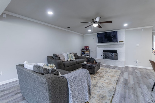 2801 Peachtree Ln, Pantego, TX 76013 - living room with ceiling fan, a brick fireplace, wood finished floors, crown molding, and baseboards