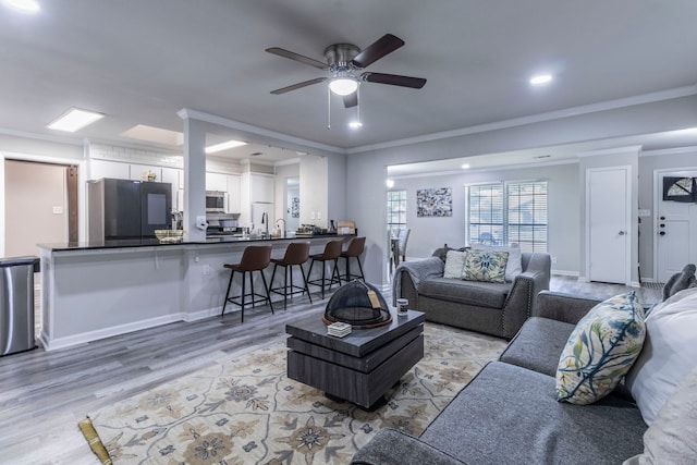 2801 Peachtree Ln, Pantego, TX 76013 - living room with light wood finished floors, ceiling fan, and crown molding