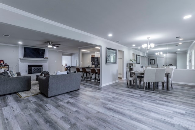 2801 Peachtree Ln, Pantego, TX 76013 - living area featuring a chandelier, baseboards, recessed lighting, a brick fireplace, and wood finished floors