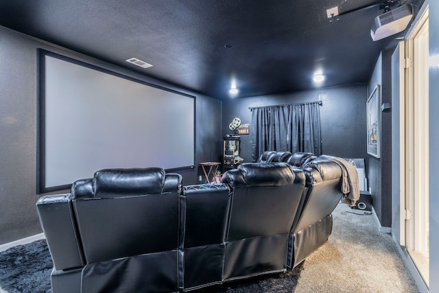 2801 Peachtree Ln, Pantego, TX 76013 - cinema featuring a textured wall, baseboards, carpet flooring, and a textured ceiling