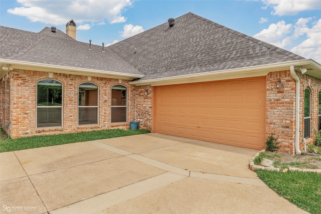 532 Hunters Run, Bossier City, LA 71111 - view of front of house with a shingled roof, brick siding, driveway, and an attached garage