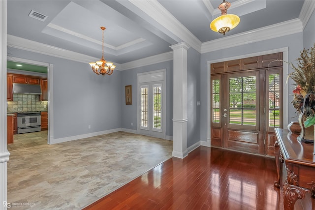 532 Hunters Run, Bossier City, LA 71111 - foyer with ornate columns, a chandelier, a tray ceiling, ornamental molding, and light wood-type flooring
