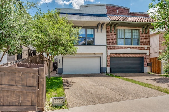 5006 Mission Ave, Dallas, TX 75206 - view of front of house with an attached garage, driveway, brick siding, and fence