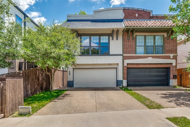 5006 Mission Ave, Dallas, TX 75206 - view of front of property featuring concrete driveway, a garage, brick siding, and fence