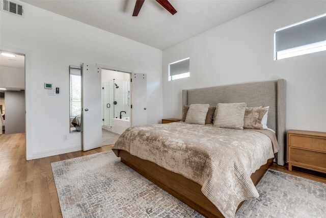 5006 Mission Ave, Dallas, TX 75206 - bedroom with wood finished floors, ceiling fan, and connected bathroom