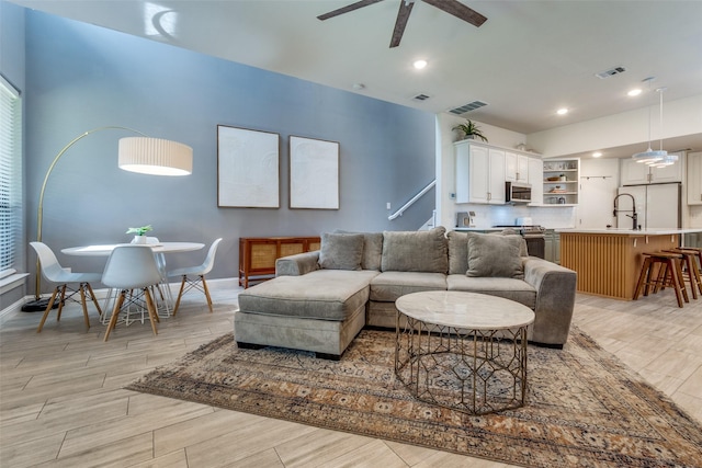 5006 Mission Ave, Dallas, TX 75206 - living room featuring a ceiling fan, light wood-style floors, baseboards, and recessed lighting