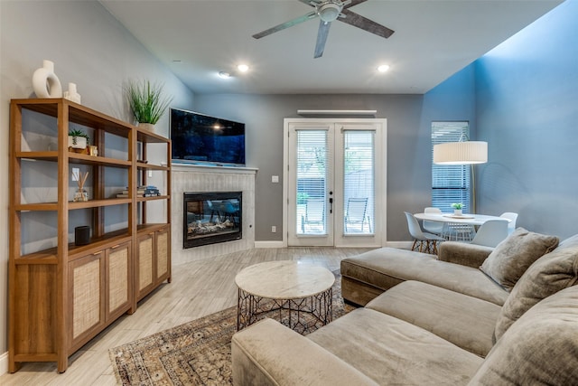 5006 Mission Ave, Dallas, TX 75206 - living room with light wood-type flooring, baseboards, ceiling fan, a fireplace, and french doors