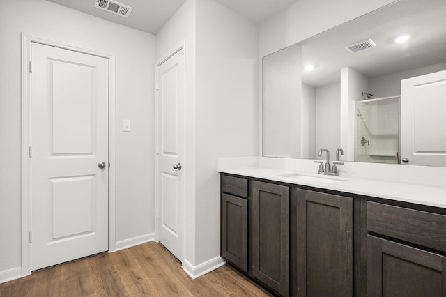 432 Gib Woodall Dr, Venus, TX 76084 - bathroom with wood finished floors, an enclosed shower, vanity, and baseboards