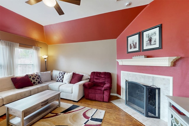 203 Millington Trl, Mansfield, TX 76063 - living area with vaulted ceiling, ceiling fan, light wood finished floors, and a tiled fireplace