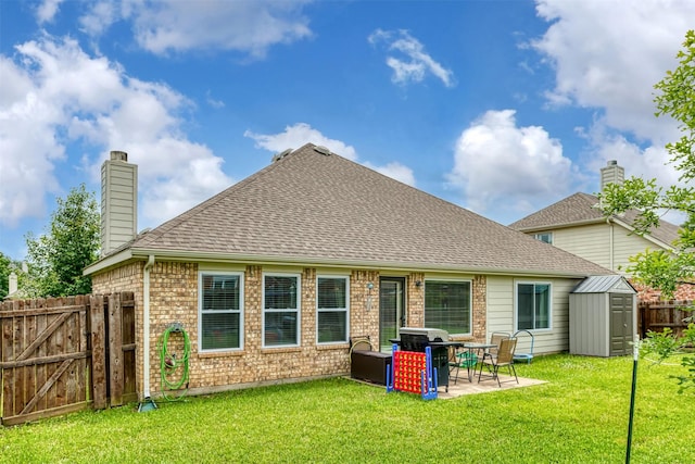 203 Millington Trl, Mansfield, TX 76063 - back of property with a storage unit, a chimney, a patio, brick siding, and an outbuilding