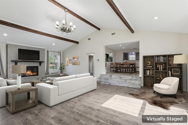 7613 Hewitt St, North Richland Hills, TX 76182 - living room with wood finished floors, a brick fireplace, a chandelier, and recessed lighting