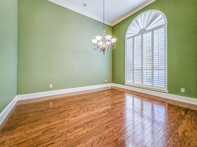 2215 Firestone Cir, Tyler, TX 75703 - spare room with ornamental molding, wood finished floors, a chandelier, plenty of natural light, and baseboards