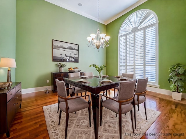 2215 Firestone Cir, Tyler, TX 75703 - dining space featuring ornamental molding, dark wood-type flooring, baseboards, and a chandelier