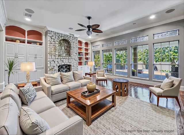 2215 Firestone Cir, Tyler, TX 75703 - living room with ornamental molding, hardwood / wood-style flooring, ceiling fan, a fireplace, and built in features