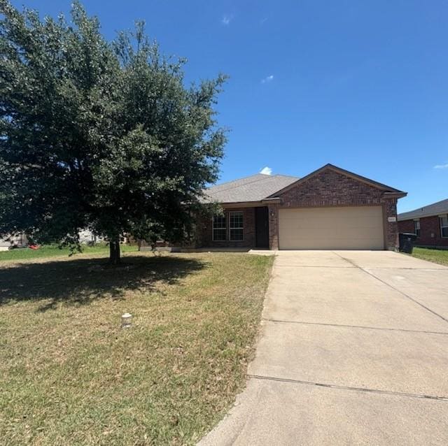 10237 Marigold Rd, Waco, TX 76708 - view of front of home with a garage, driveway, a front yard, and brick siding