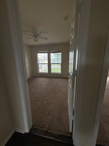 10237 Marigold Rd, Waco, TX 76708 - hallway with dark colored carpet and baseboards