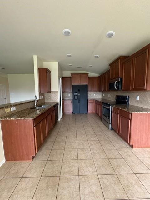 10237 Marigold Rd, Waco, TX 76708 - kitchen with stainless steel appliances, a sink, tasteful backsplash, dark stone countertops, and light tile patterned floors