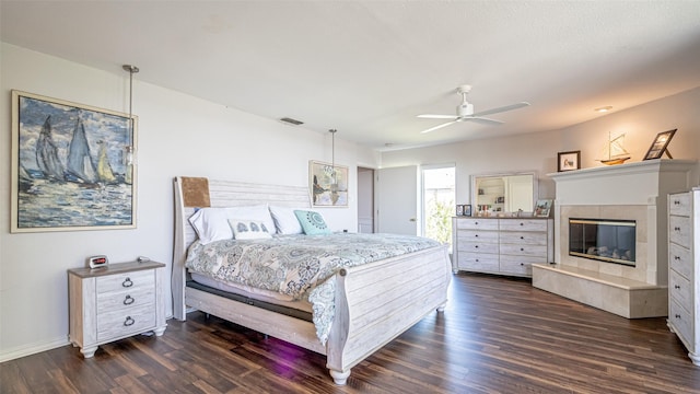 4536 Overlook Ct, Granbury, TX 76049 - bedroom with dark wood-style floors, a tile fireplace, baseboards, and a ceiling fan