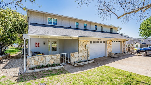 4536 Overlook Ct, Granbury, TX 76049 - view of front of home with concrete driveway, stone siding, a shingled roof, a porch, and an attached garage