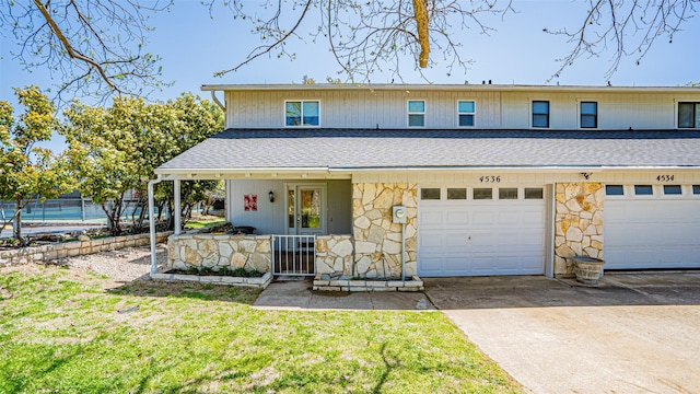 4536 Overlook Ct, Granbury, TX 76049 - view of property featuring stone siding, roof with shingles, driveway, and a porch