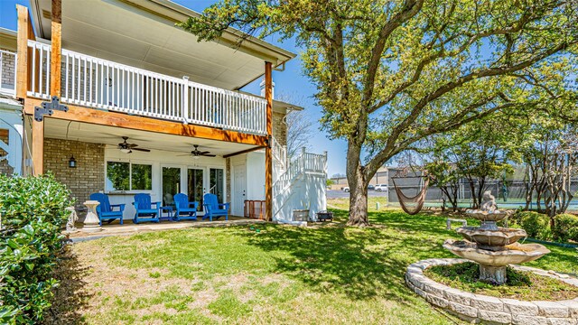 4536 Overlook Ct, Granbury, TX 76049 - back of house with a ceiling fan, a yard, and a balcony