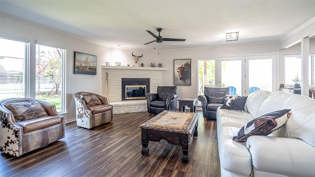 4536 Overlook Ct, Granbury, TX 76049 - living area with a ceiling fan, crown molding, dark wood-type flooring, a brick fireplace, and french doors