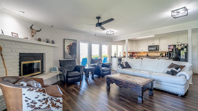 4536 Overlook Ct, Granbury, TX 76049 - living room featuring dark wood-type flooring, a ceiling fan, crown molding, and a brick fireplace