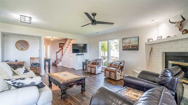 4536 Overlook Ct, Granbury, TX 76049 - living area with crown molding, ceiling fan, stairs, wood finished floors, and a brick fireplace