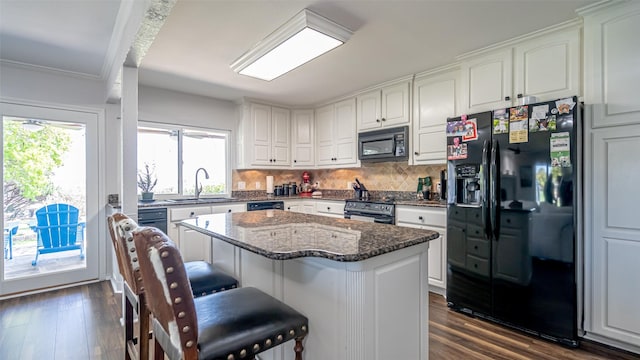 4536 Overlook Ct, Granbury, TX 76049 - kitchen with black appliances, a sink, white cabinets, dark wood-style flooring, and ornamental molding