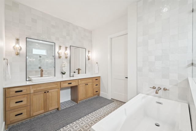 full bath with a soaking tub, double vanity, and tile patterned floors