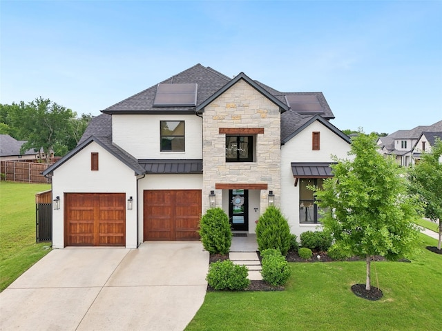 view of front of home with concrete driveway, a shingled roof, a standing seam roof, solar panels, and a garage