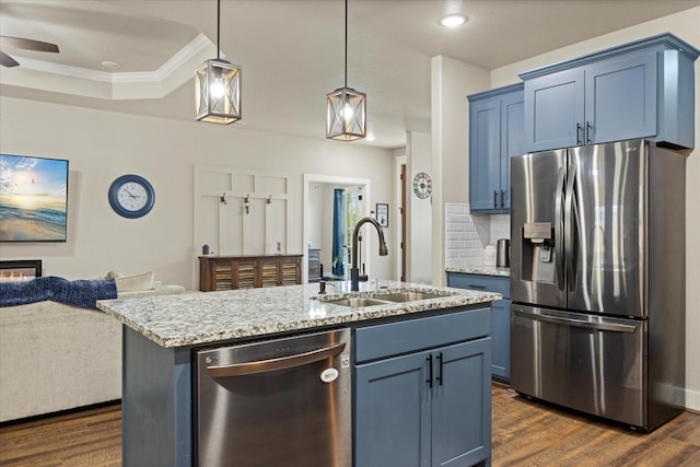 2610 Austin Dr, Granbury, TX 76048 - kitchen with appliances with stainless steel finishes, a sink, crown molding, open floor plan, and dark wood finished floors