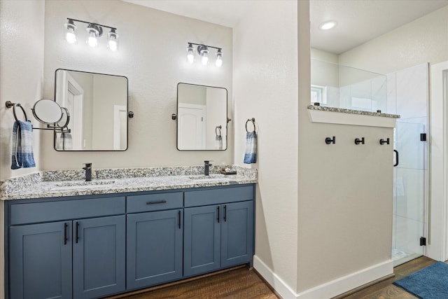 2610 Austin Dr, Granbury, TX 76048 - full bath featuring a shower stall, wood finished floors, double vanity, and baseboards