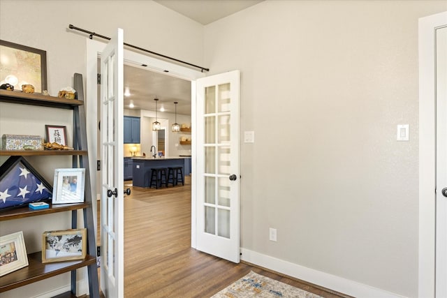 2610 Austin Dr, Granbury, TX 76048 - doorway to outside with french doors, wood finished floors, and baseboards