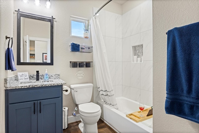 2610 Austin Dr, Granbury, TX 76048 - bathroom with wood finished floors, shower / tub combo, toilet, vanity, and a textured wall