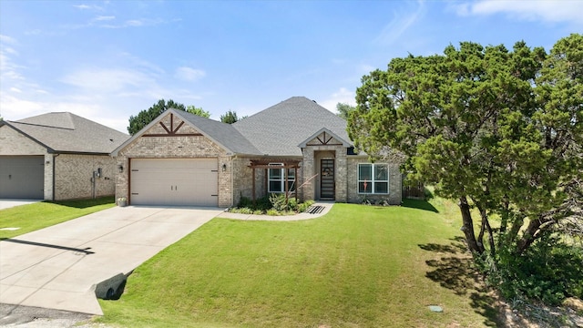 2610 Austin Dr, Granbury, TX 76048 - view of front of house with brick siding, an attached garage, a front yard, concrete driveway, and a shingled roof