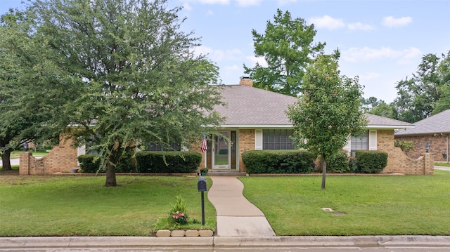 805 Sandpiper Dr, Denton, TX 76205 - view of property hidden behind natural elements with brick siding, a front yard, and a chimney