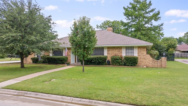 805 Sandpiper Dr, Denton, TX 76205 - view of front of property featuring a front yard, a chimney, brick siding, and a shingled roof