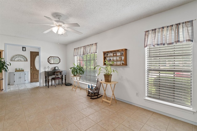805 Sandpiper Dr, Denton, TX 76205 - sitting room featuring ceiling fan, a textured ceiling, and light tile patterned floors